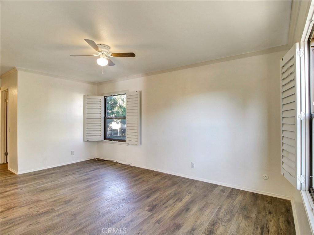 9051 Cobblestone Lane, Unit 40 Cypress, CA 90630 - Photo 29 of 38 a view of an empty room with wooden floor and a window