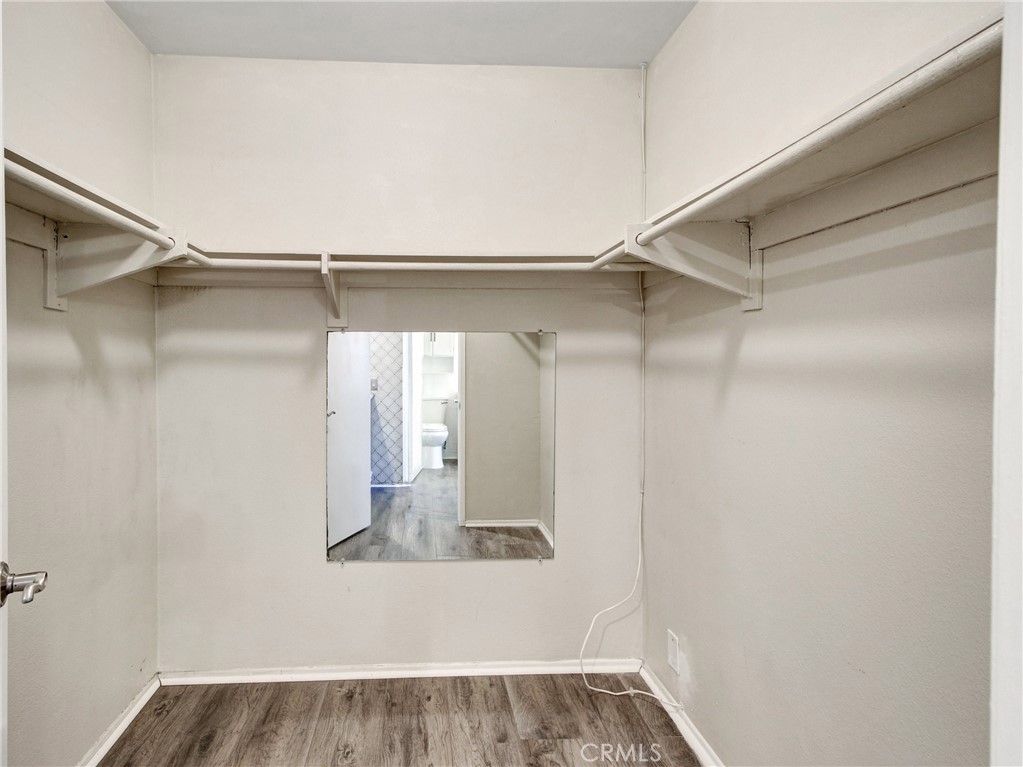 9051 Cobblestone Lane, Unit 40 Cypress, CA 90630 - Photo 31 of 38 a view of walk in closet with clothes and shoes