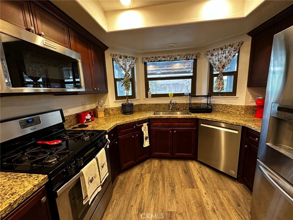 9051 Cobblestone Lane, Unit 40 Cypress, CA 90630 - Photo 7 of 38 a kitchen with a stove a sink and a microwave