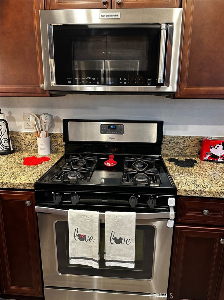 9051 Cobblestone Lane, Unit 40 Cypress, CA 90630 - Photo 9 of 38 a stove top oven sitting inside of a kitchen