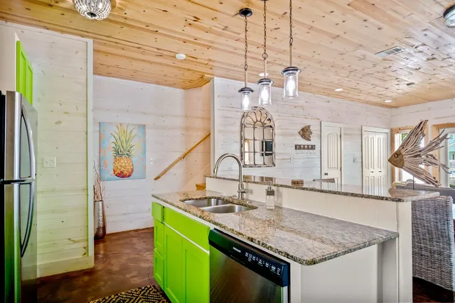 a bathroom with a granite countertop sink a mirror and shower