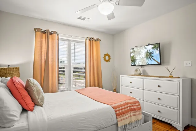 a front view of a house with a porch and a garden