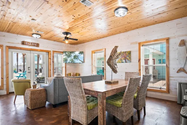 a dining room with furniture window and wooden floor