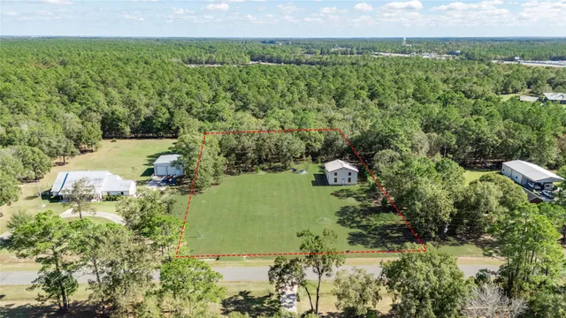 an aerial view of a houses with a yard