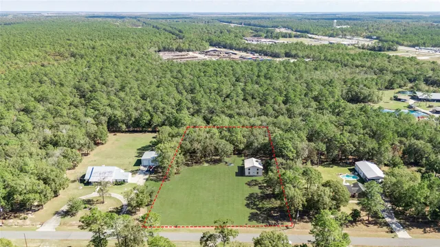 an aerial view of a houses with a yard
