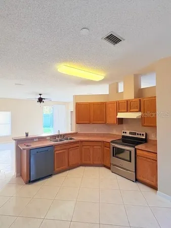 a kitchen with stainless steel appliances granite countertop a sink and a stove