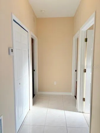 a view of a hallway to rooms