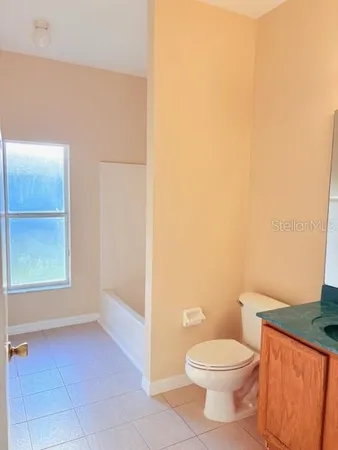 a white toilet sitting next to a window