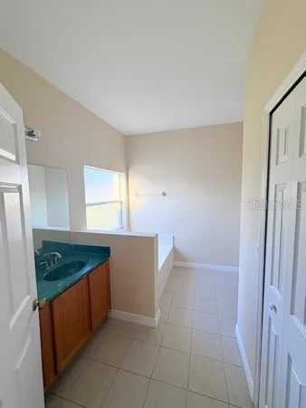 a kitchen with sink and cabinets