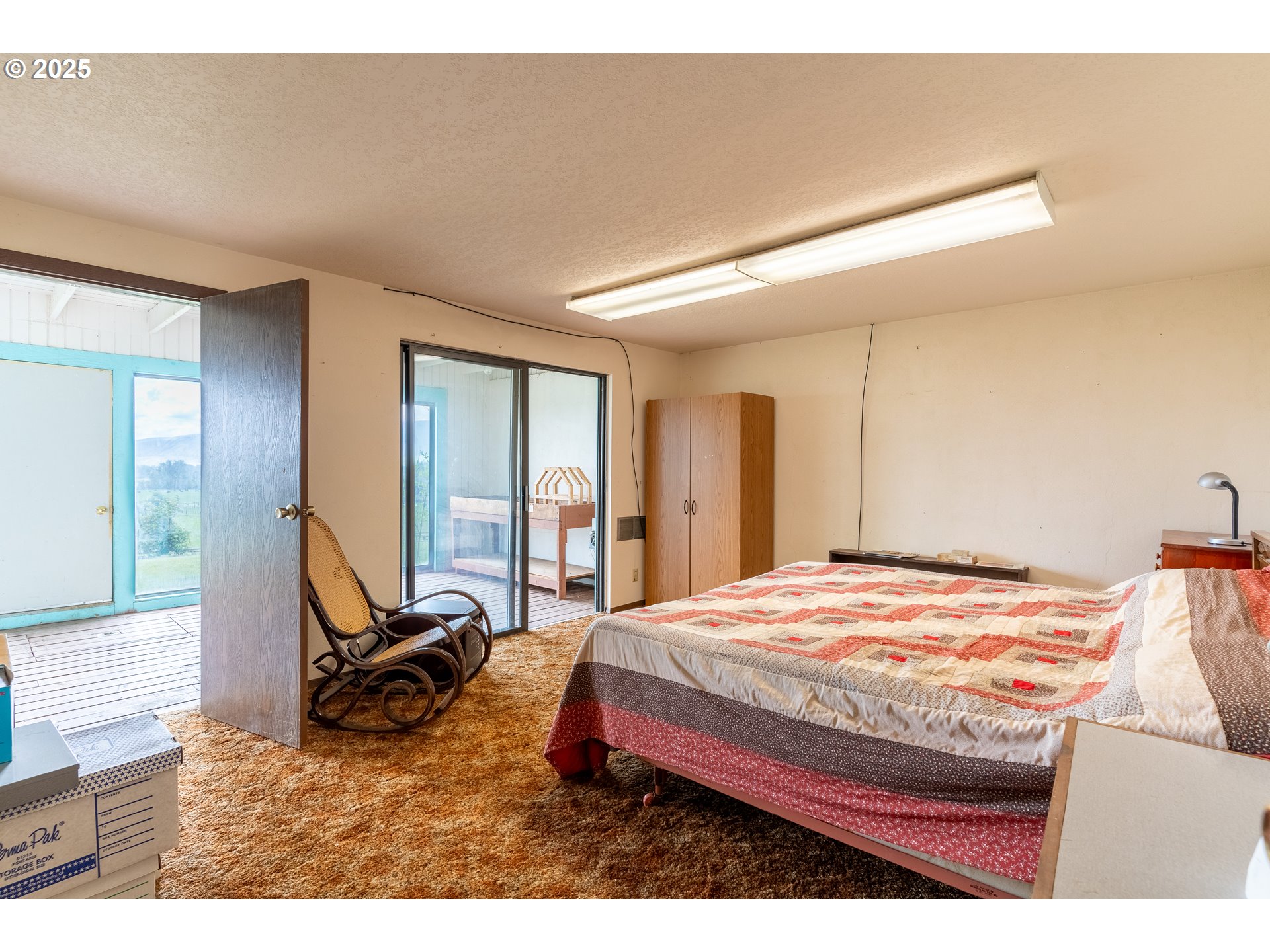 47433 Slaughterhouse Road Halfway, OR 97834 - Photo 16 of 16 a bedroom with a bed a table and chair