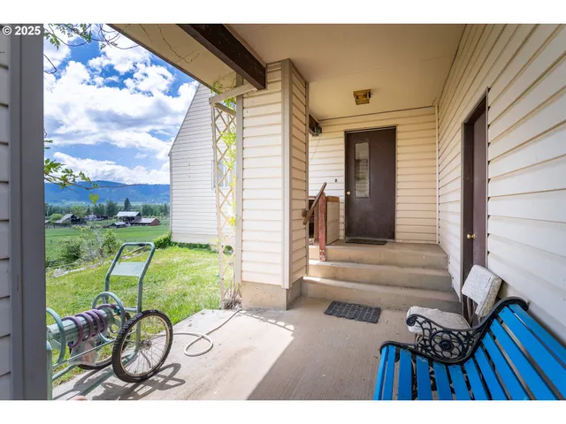 a view of a porch with a table and chairs