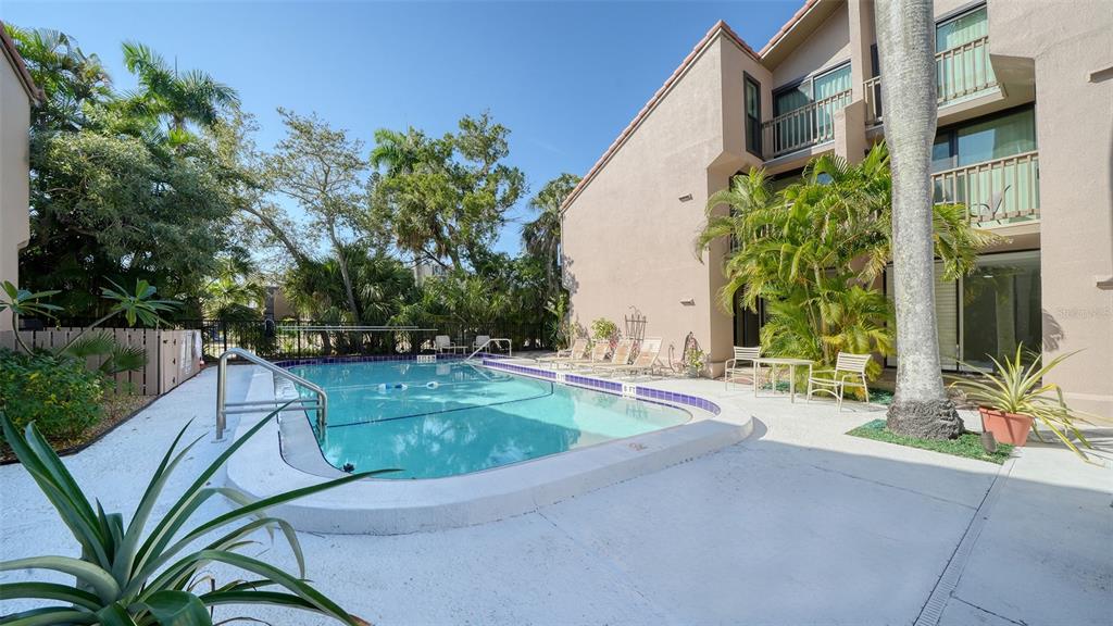 117 Pass Key Road, Unit 117 Sarasota, FL 34242 - Photo 19 of 59 a view of backyard with swimming pool and sitting area