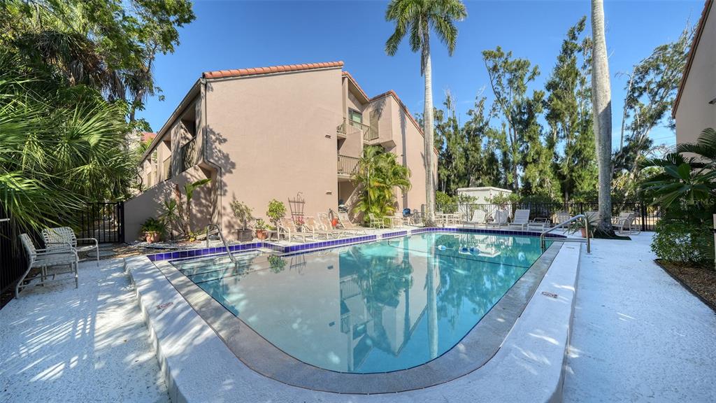 117 Pass Key Road, Unit 117 Sarasota, FL 34242 - Photo 21 of 59 a view of a swimming pool with a sitting space