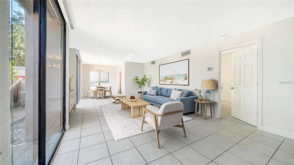 117 Pass Key Road, Unit 117 Sarasota, FL 34242 - Photo 8 of 59 a living room with patio furniture and a view of bathroom