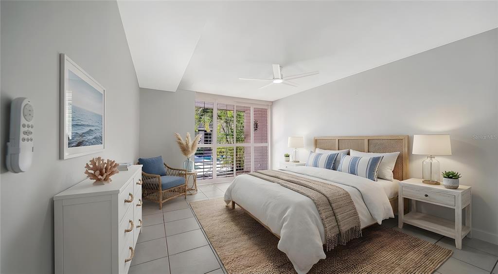 117 Pass Key Road, Unit 117 Sarasota, FL 34242 - Photo 9 of 59 a bedroom with a bed and wooden floor