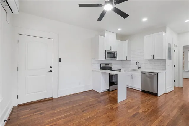 a kitchen with white cabinets and white appliances