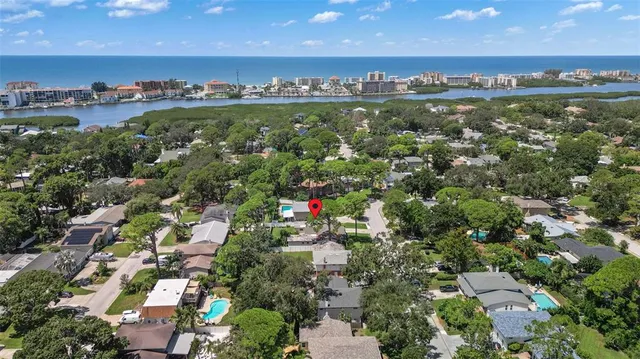 an aerial view of beach and residential building with outdoor space and building