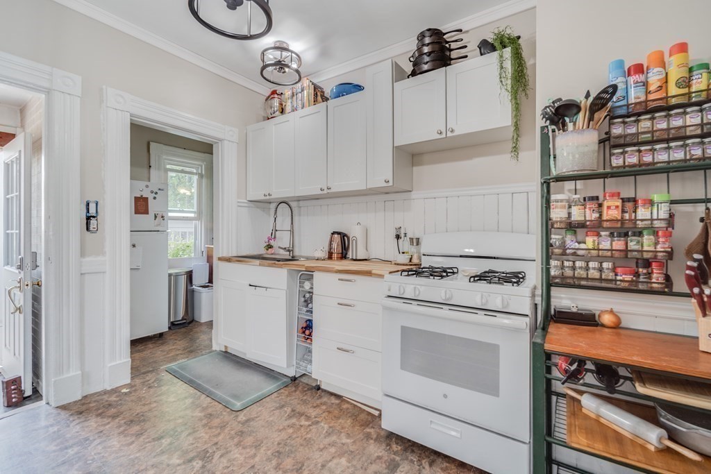 37 Phoenix Street Springfield, MA 01104 - Photo 11 of 27 a kitchen with white cabinets and white appliances