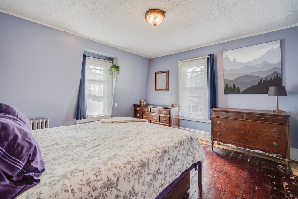 37 Phoenix Street Springfield, MA 01104 - Photo 14 of 27 a bedroom with a bed and a flat screen tv