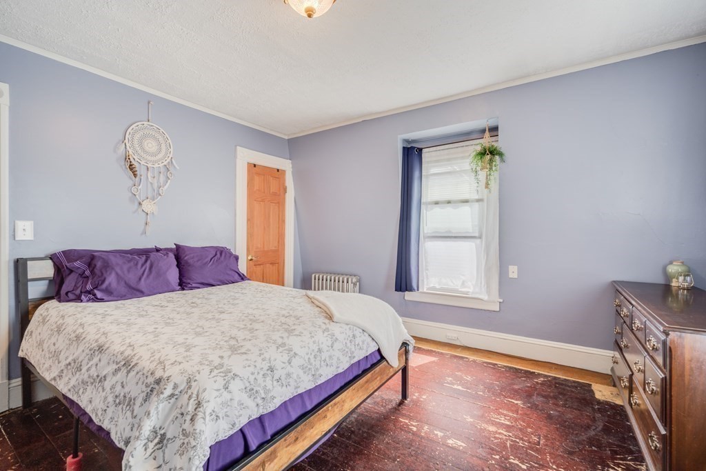 37 Phoenix Street Springfield, MA 01104 - Photo 15 of 27 a bedroom with a bed and a window