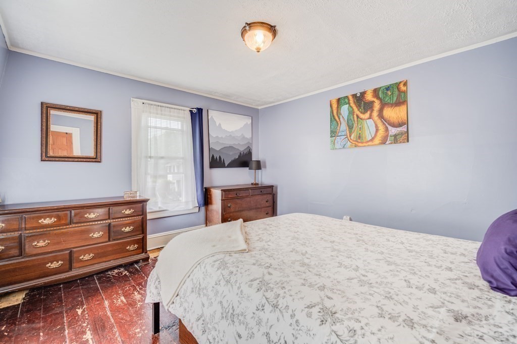 37 Phoenix Street Springfield, MA 01104 - Photo 16 of 27 a bedroom with a bed and wooden floor