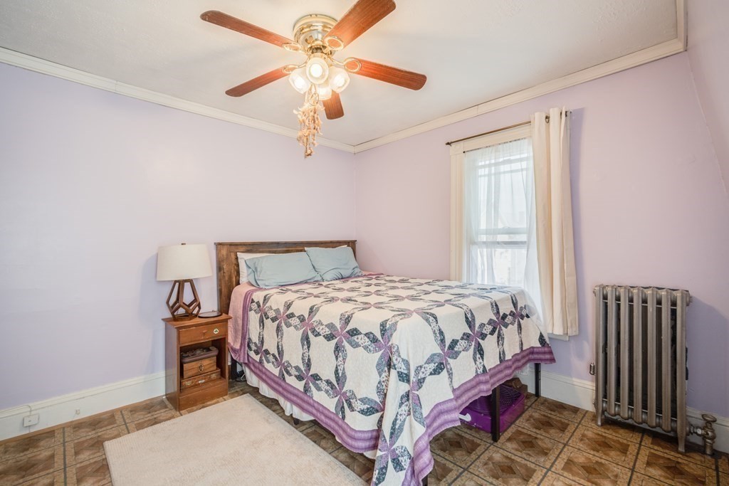 37 Phoenix Street Springfield, MA 01104 - Photo 17 of 27 a bedroom with a bed and a chandelier