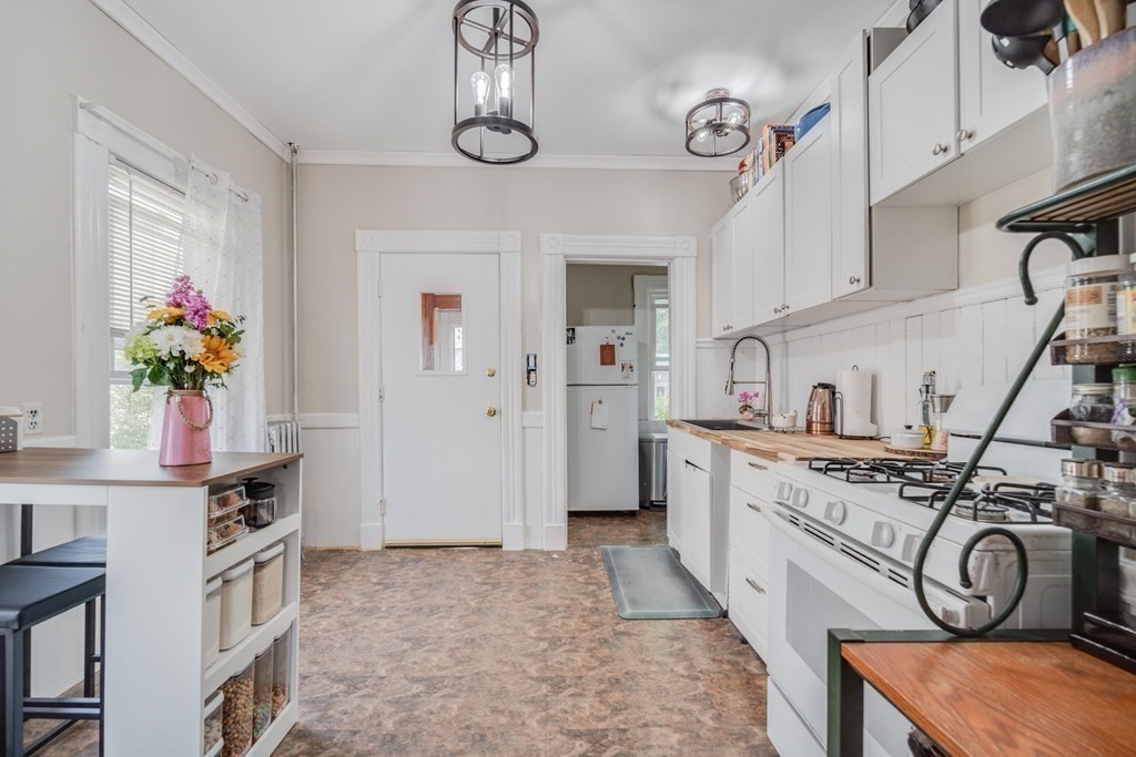 37 Phoenix Street Springfield, MA 01104 - Photo 9 of 27 a kitchen with stainless steel appliances granite countertop a stove a sink and a refrigerator