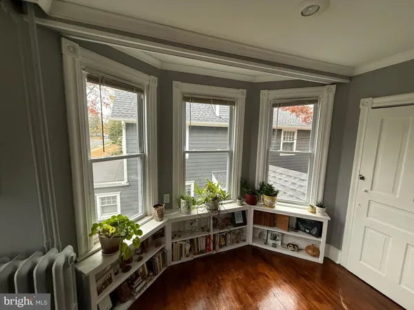 a view of a room with wooden floor and furniture