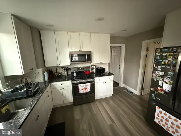 a kitchen with stainless steel appliances a refrigerator stove microwave and sink