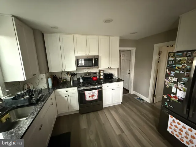 a kitchen with stainless steel appliances a refrigerator stove microwave and sink