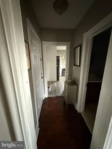 a view of a hallway with a livingroom and furniture