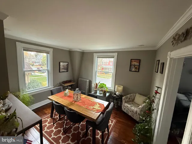 a view of a livingroom with furniture window and a wooden floor
