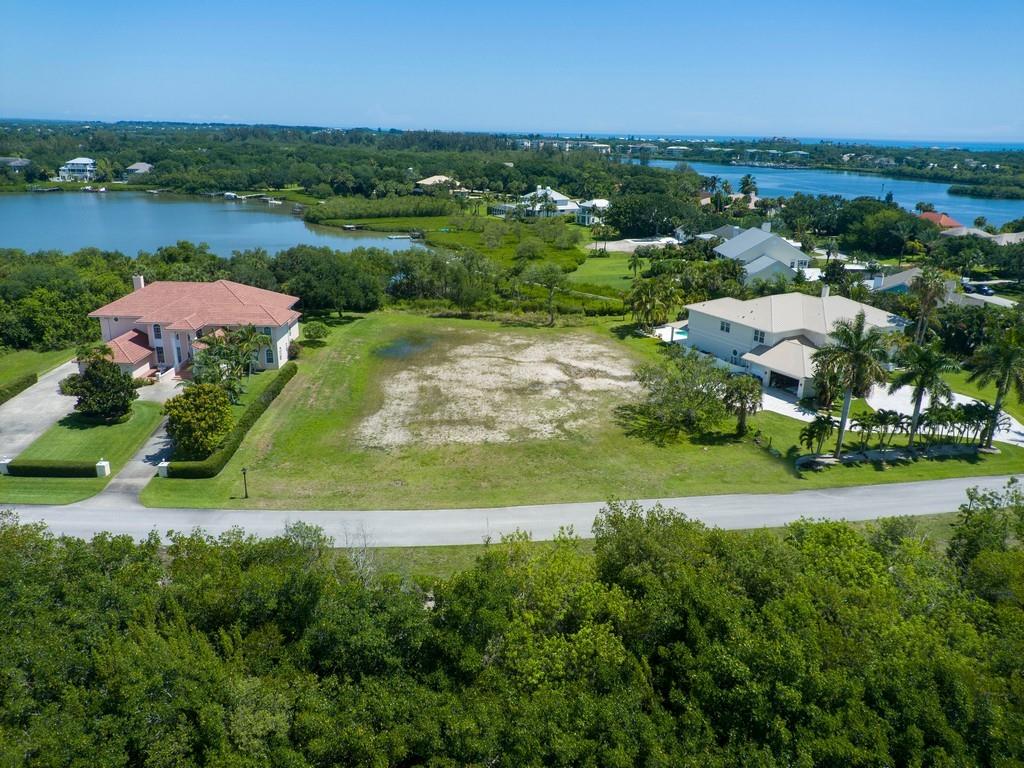 an aerial view of residential houses with outdoor space and river