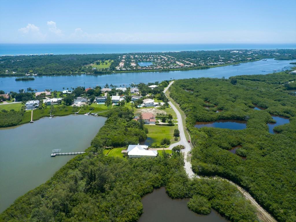 1850 Bayview Court Vero Beach, FL 32963 - Photo 17 of 23 an aerial view of a city with lots of residential buildings and mountain view in back