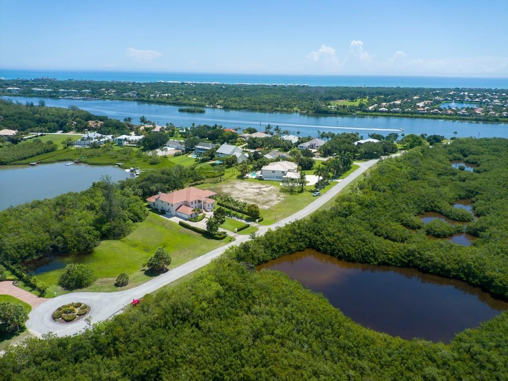 1850 Bayview Court Vero Beach, FL 32963 - Photo 9 of 23 an aerial view of green landscape with trees houses and lake view