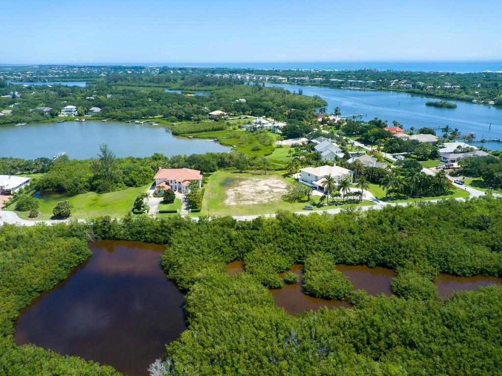 1850 Bayview Court Vero Beach, FL 32963 - Photo 10 of 23 an aerial view of green landscape with trees houses and lake view