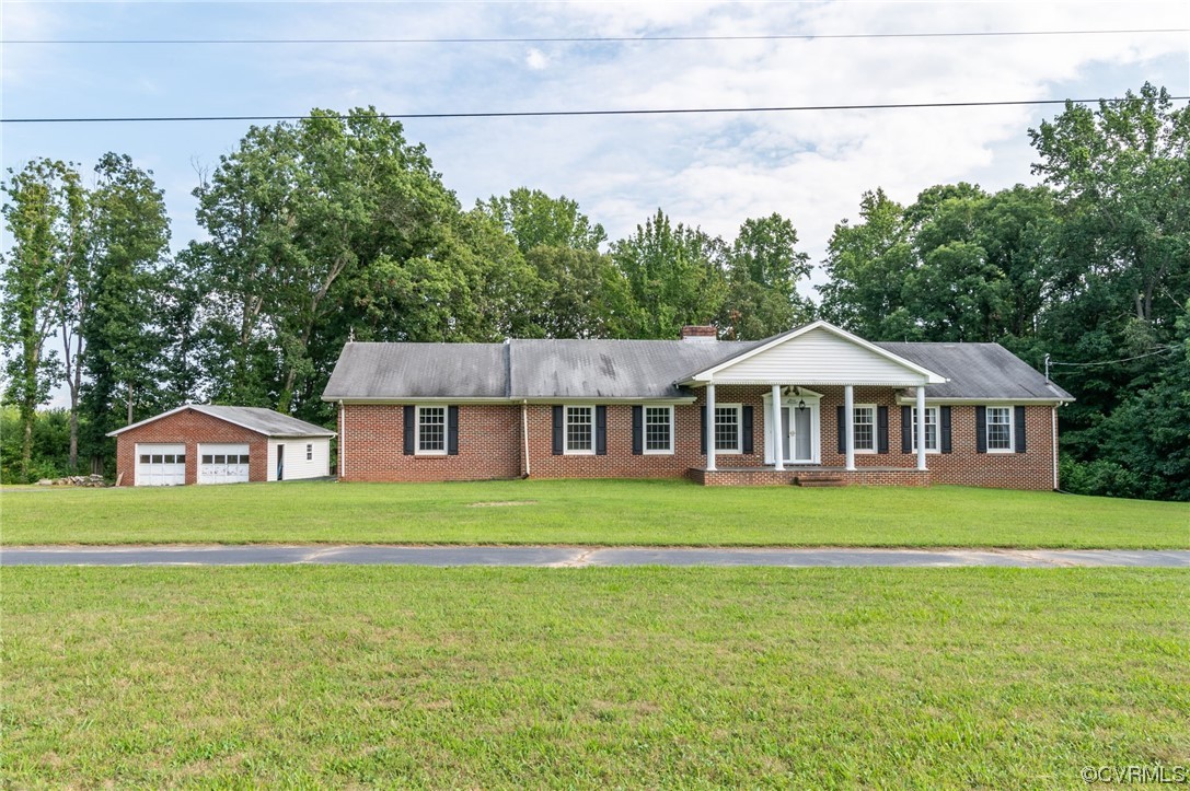 7000 Venable Road Kents Store, VA 23084 - Photo 1 of 45 a front view of a house with a garden