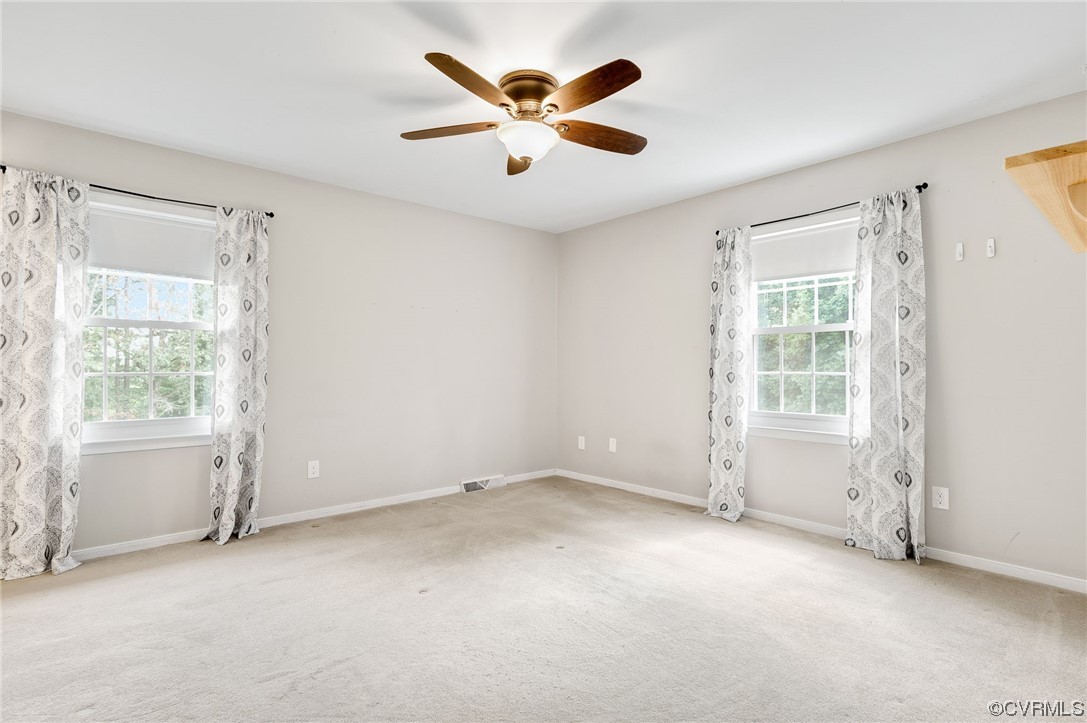 7000 Venable Road Kents Store, VA 23084 - Photo 13 of 45 an empty room with windows and ceiling fan
