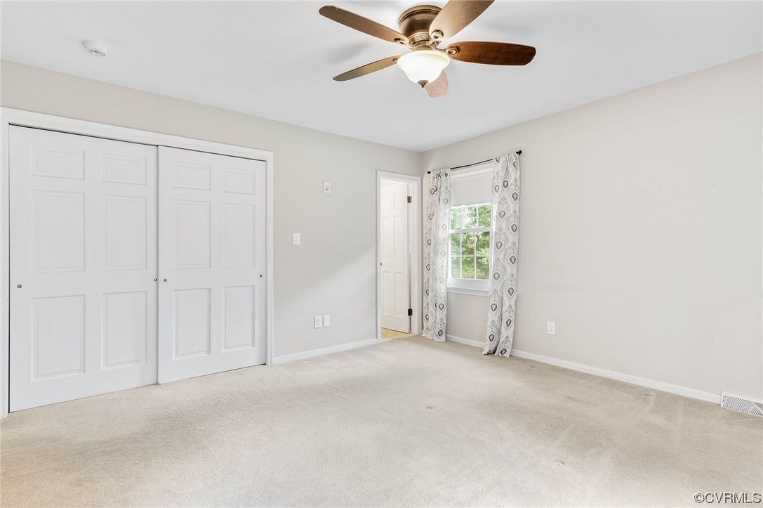 7000 Venable Road Kents Store, VA 23084 - Photo 14 of 45 an empty room with windows and fan