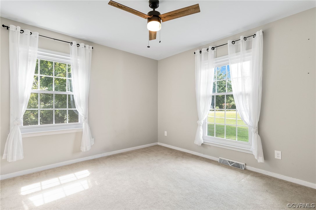 7000 Venable Road Kents Store, VA 23084 - Photo 19 of 45 an empty room with windows and ceiling fan
