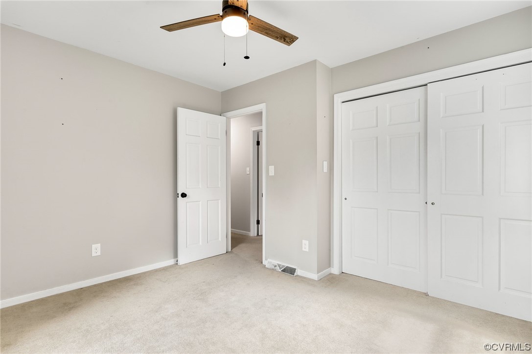 7000 Venable Road Kents Store, VA 23084 - Photo 20 of 45 an empty room with a ceiling fan and carpet