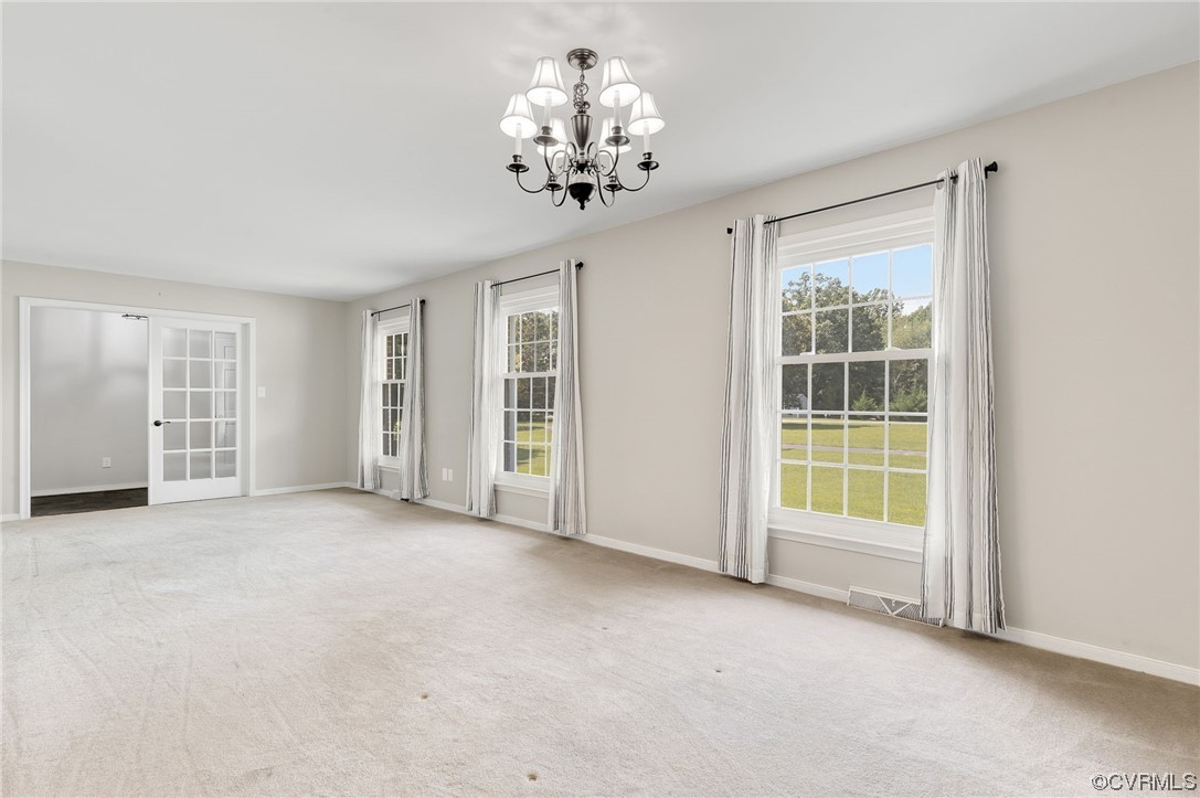 7000 Venable Road Kents Store, VA 23084 - Photo 4 of 45 an empty room with chandelier and windows