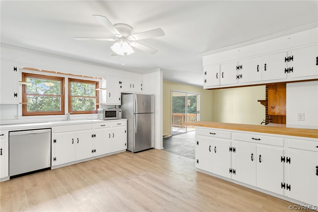 7000 Venable Road Kents Store, VA 23084 - Photo 7 of 45 a kitchen with granite countertop a stove a sink a refrigerator and white cabinets with wooden floor