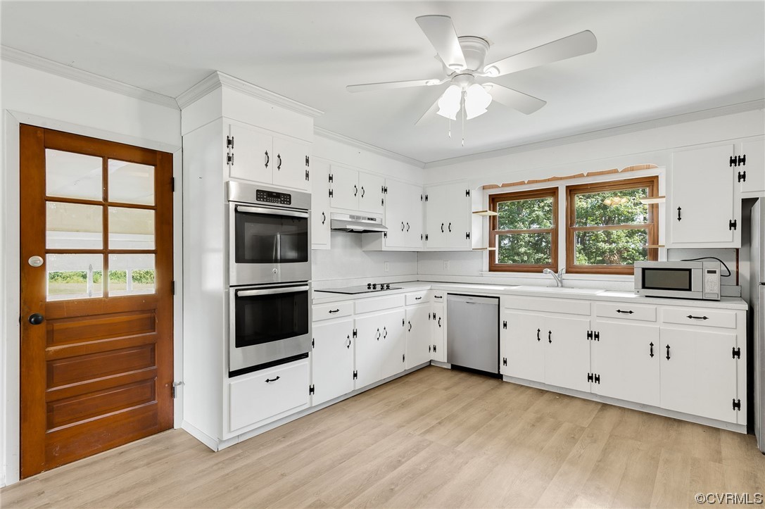 7000 Venable Road Kents Store, VA 23084 - Photo 8 of 45 a kitchen with granite countertop white cabinets white stainless steel appliances and window