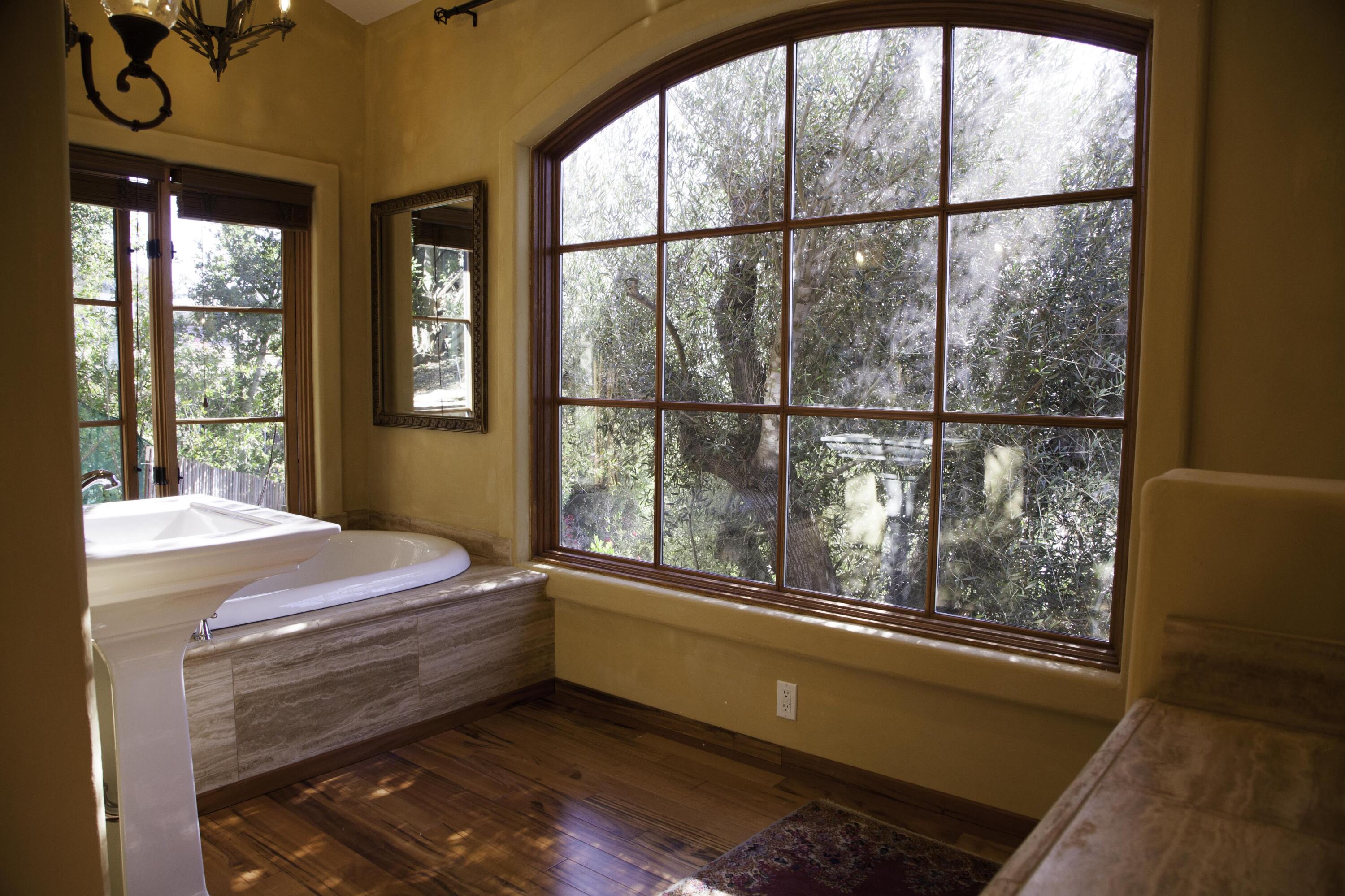 1933 Eucalyptus Hill Road Santa Barbara, CA 93108 - Photo 6 of 11 a room with a bed and large window
