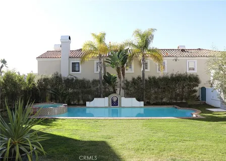 a swimming pool with outdoor seating and yard