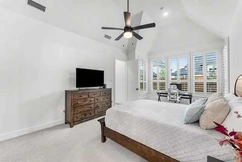 a bedroom with a bed and a flat screen tv