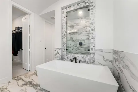 a bathroom with a bathtub and a shower