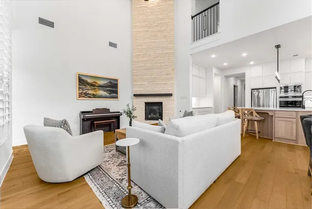 a living room with furniture wooden floor and a fireplace