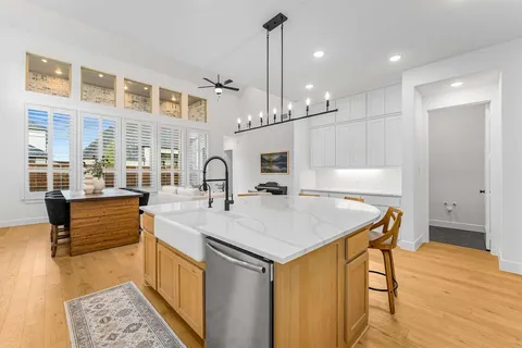 a kitchen with a sink a counter top space and stainless steel appliances